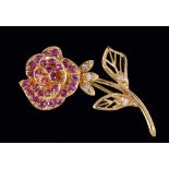 A Ruby and Diamond Rose Brooch pavé-set round rubies to flower and brilliant-cut diamonds to leaves,