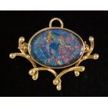 An Opal Pendant/Brooch, the close-set oval stone in 18ct gold mount