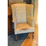 A 19th Century upholstered wing Armchair in the Georgian style on turned front supports and casters