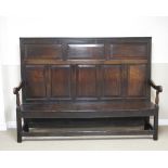 An 18th Century oak Settle with panelled back, shaped arms on squared supports and stretchers, 6ft