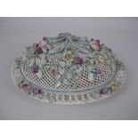 A Belleek porcelain oval latticework Basket and Cover with polychrome floral encrustation, 13in, and