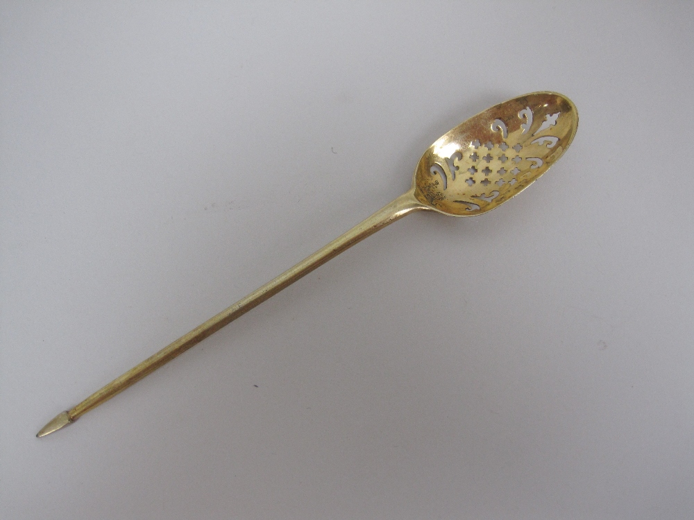 An 18th Century silver-gilt Mote Spoon with saltire cross and scroll piercing, engraved crest