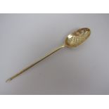 An 18th Century silver-gilt Mote Spoon with saltire cross and scroll piercing, engraved crest