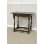 A 17th Century oak Side Table fitted frieze drawer on turned and square front legs united by