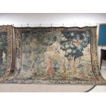 A 17th Century Flemish Verdure Tapestry of figures in an extensive landscape of trees and shrubs