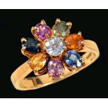 A gem-set Flower Cluster Ring claw-set round sapphire within a frame of oval-cut sapphires in