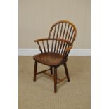 A 18th Century yewwood and ash Child's Chair, the hoop back and arms above a shaped seat on turned