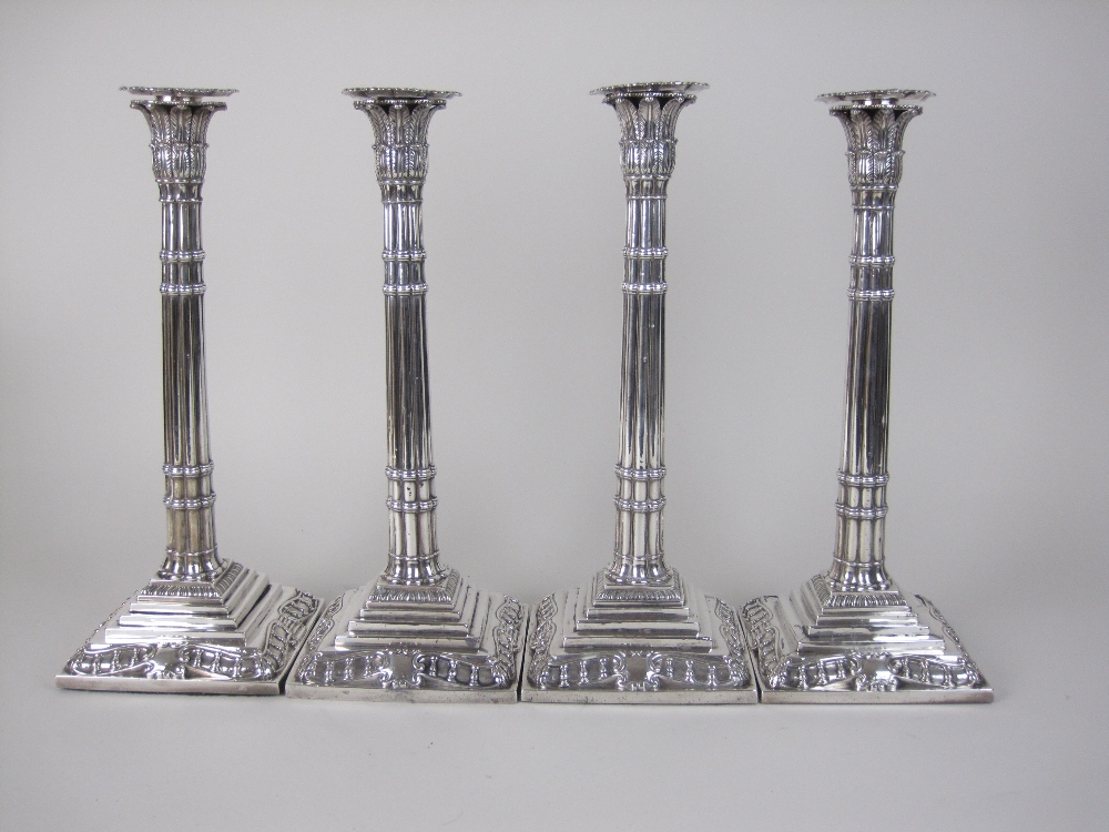 A Set of four George II silver Candlesticks with fluted columns having papyrus sconces, detachable