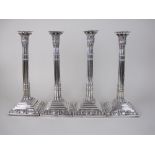 A Set of four George II silver Candlesticks with fluted columns having papyrus sconces, detachable