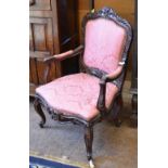 A pair of Georgian style Elbow Chairs with floral and leafage carved framed and cushioned pink