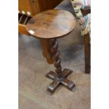 An antique elm Candle Stand with circular top on spiral column having cruciform base, 13 1/2 in