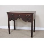 A 18th Century mahogany Lowboy fitted one long and two short drawers around a shaped frieze on