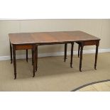 An early 19th Century mahogany Extending Dining Table having pair of D ends and central section with