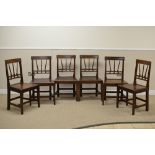 A Set of six early 19th Century fruitwood Dining Chairs with reeded top rails above triple spindle