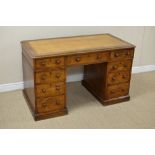 A 19th Century oak Kneehole Desk with inset brown leather writing surface above nine drawers, 4ft