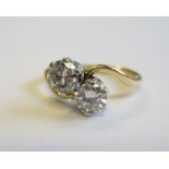 A Diamond two stone Crossover Ring claw-set brilliant-cut stones, estimated total weight 1ct,