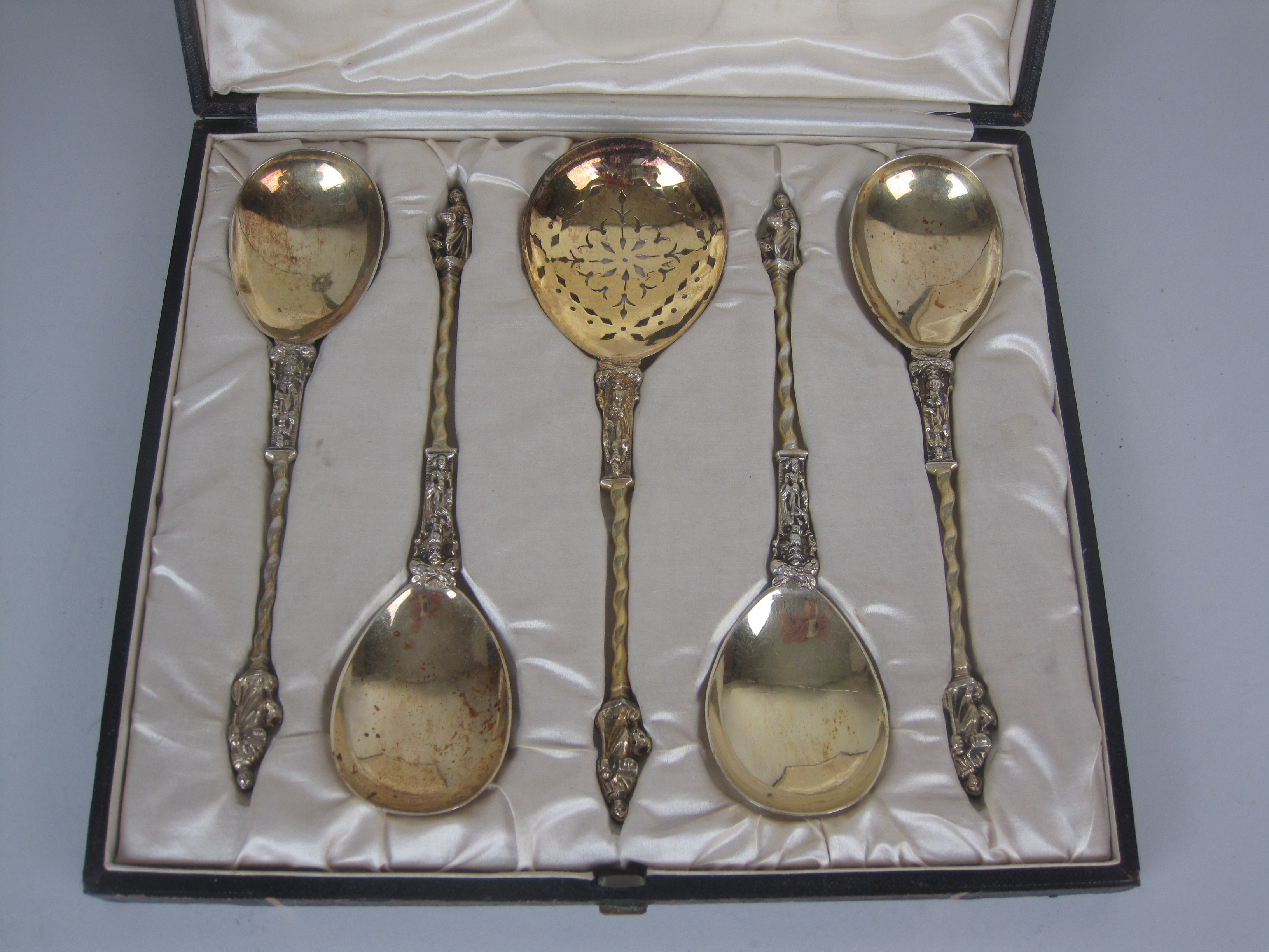 Four Victorian silver-gilt apostle handled Serving Spoons with spiral stems, London 1887/8 and a