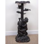 A Black Forest Jardiniere Stand in the form of two cherubs holding a tree with birds in the