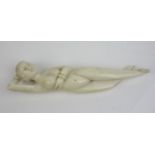 A Chinese ivory 'Doctors Model' reclining holding her hand behind her head, 9 1/4 in L