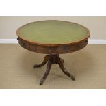 A 19th Century oak Drum Table, the leather inset circular top above two drawers and six false