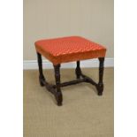 An antique oak Stool with upholstered seat on baluster turned and square supports united by H