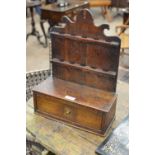 An 18th Century Oak Spoon Rack with shaped back with two rows of slots above a drawer to the box