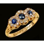 A Sapphire and Diamond triple Cluster Ring pavé-set graduated oval-cut sapphires within frames of