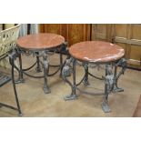 A pair of French Empire style bronze circular Occasional Tables with red marble tops and swag and