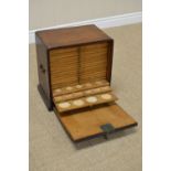 An antique oak brass handled Microscope Slide Cabinet with fall front revealing twenty two small