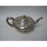 A Victorian silver Teapot of compressed circular form with floral and scroll embossing, fruit