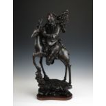 A Chinese silver wire inlaid hardwood Figure of Shoulao, c1900, seated on his stag holding his