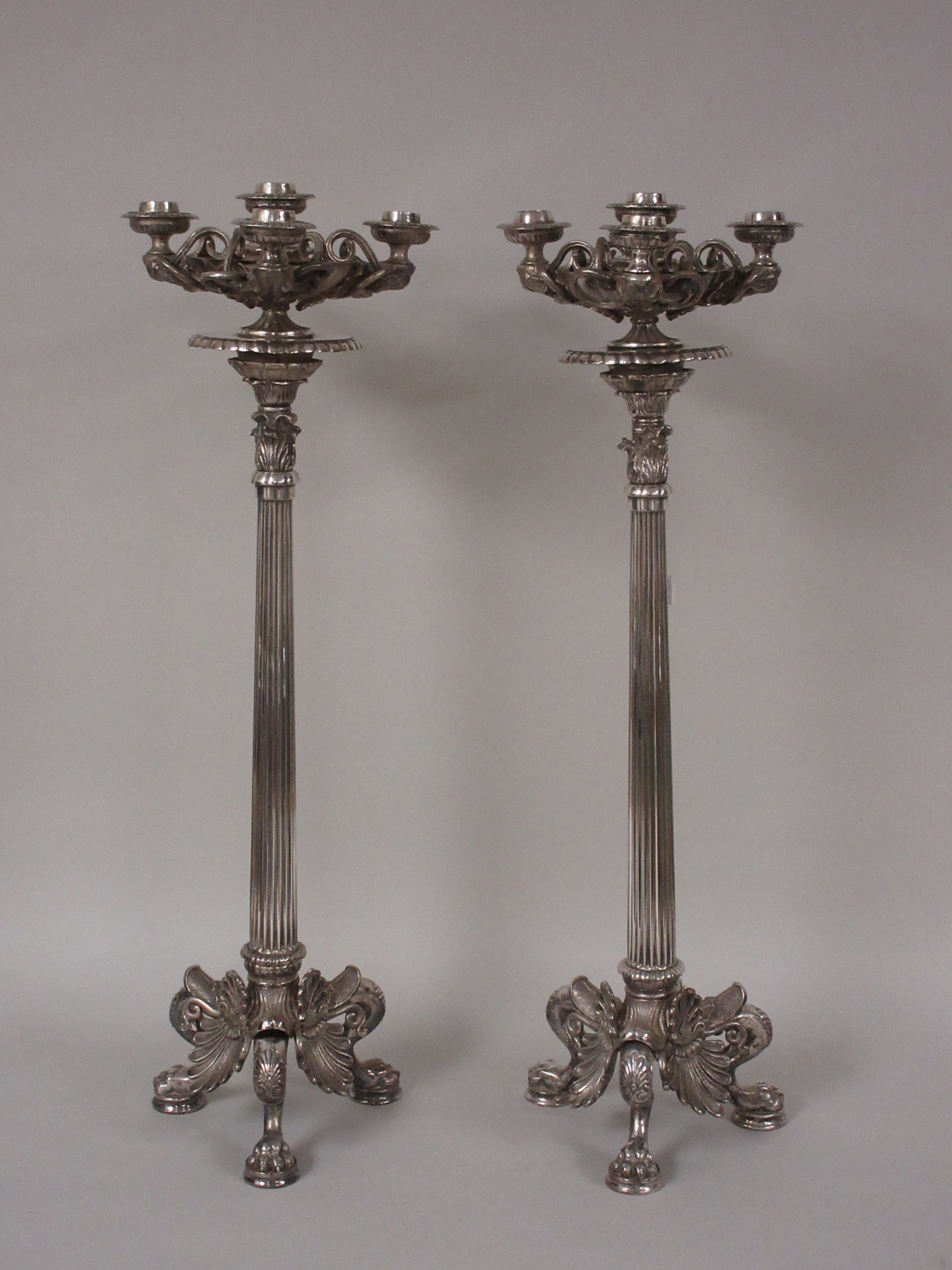 A pair of plated Table Candelabra on corinthian columns and three paw feet with scallop