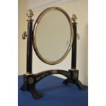 A Continental ebonised and white metal Dressing Mirror with oval plate on cheval frame with