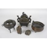 A Chinese bronze Censer, of bombé form with two loop handles, on three feet, cast 4-character mark