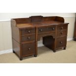 A Regency mahogany Breakfront Sideboard with low raised back, fitted seven drawers flanked by