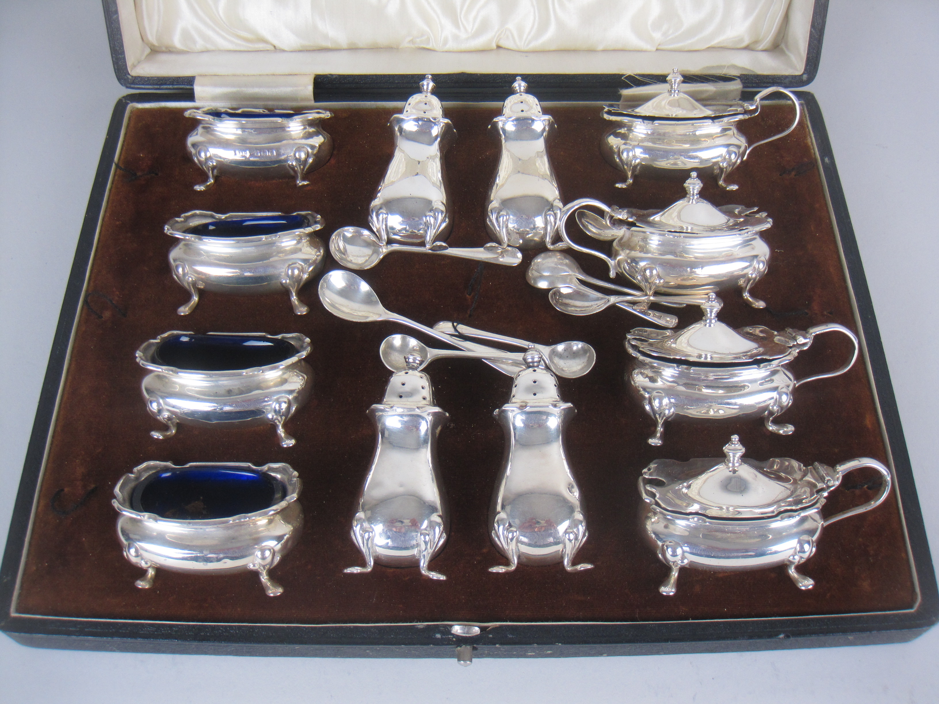 A George V silver twelve piece Condiment Set, Birmingham 1928/9, maker: Walker & Hall, cased, plus