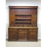An 18th Century oak Dresser and Rack the upper section fitted two panelled doors above six