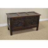 A 17th Century oak Coffer with sunken three panel lid above carved frieze, iron lockplate and pair