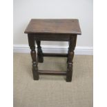 A 17th Century oak Joint Stool with moulded top on baluster turned and square legs united by