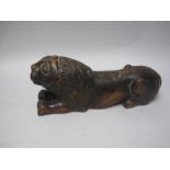 A Medieval style carved walnut Figure of a Recumbant Lion, 11 1/2in