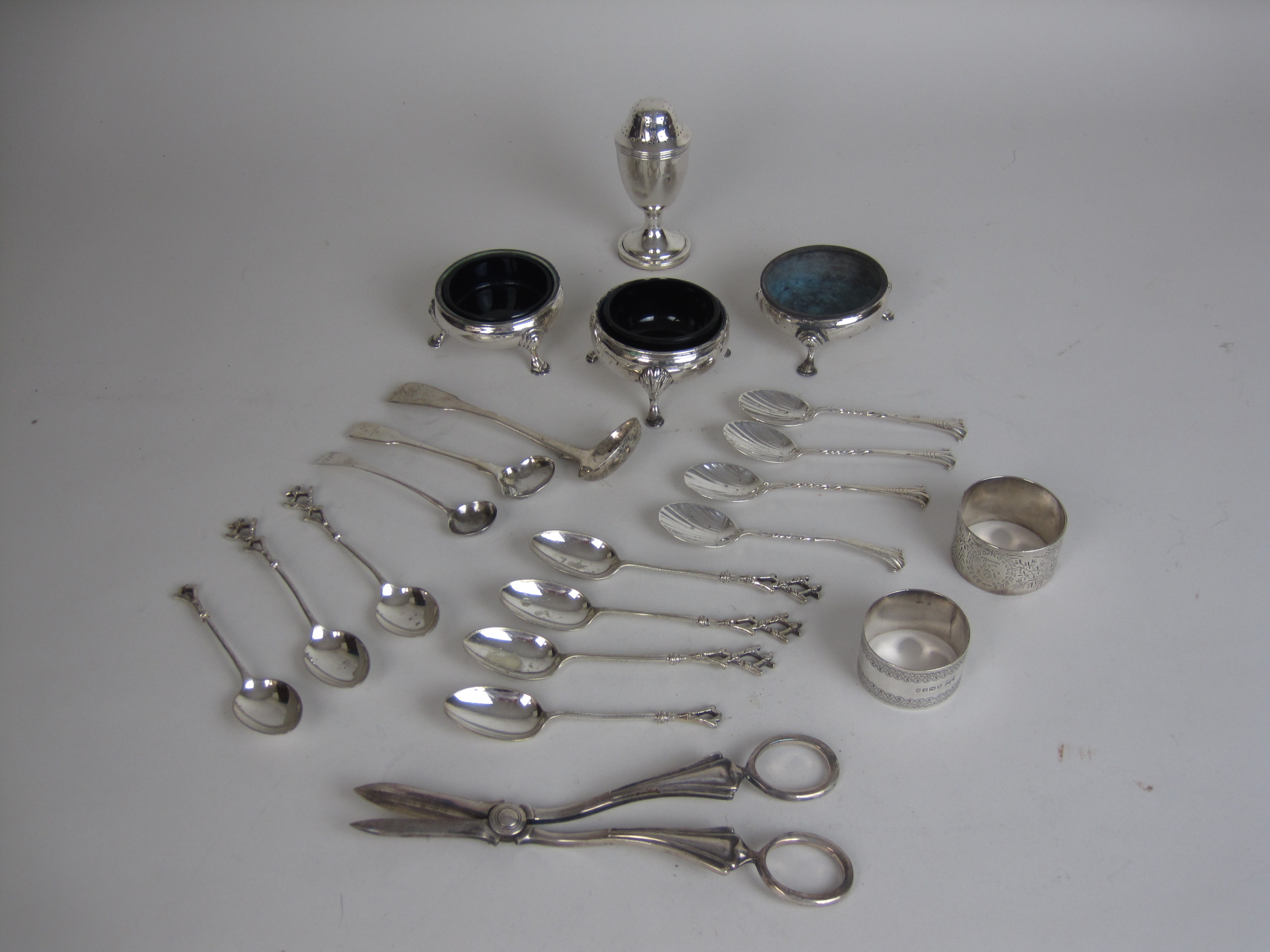 Three Georgian silver Cauldron Salts, a Pepperette, London 1911, three silver Condiment Spoons, four