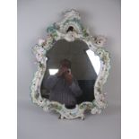 A 19th Century Dresden ornate Wall Mirror of rococo scroll design, floral encrusted and painted in