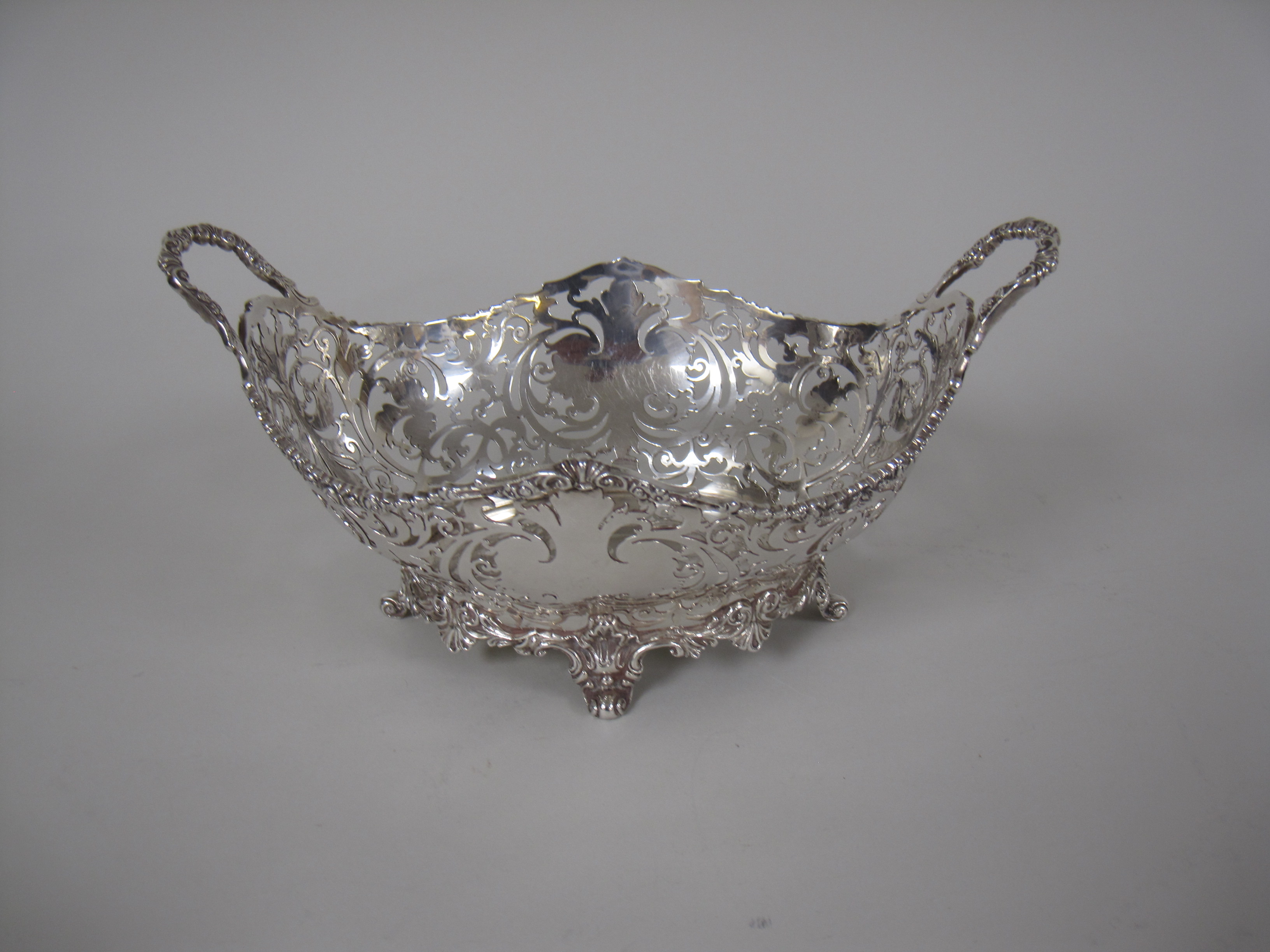 A pair of George V silver pierced oval two handled Baskets on scroll feet, London 1925, 10 x 6in, - Image 4 of 4