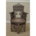 A 19th Century Anglo Indian mother of pearl inlaid hardwood Armchair with spindle panels above a