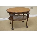 A Queen Anne style walnut shaped oval Occasional Table on scallop carved cabriole legs with ball and