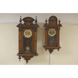 A near pair of 19th Century Vienna type Wall Clocks with circular dials, in walnut cases having