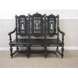 A 19th Century ebonised Settle in the 17th Century style with three panel back decorated with inlaid