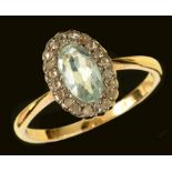 An Aquamarine and Diamond Cluster Ring set oval-cut aquamarine within frame of rose-cut diamonds,