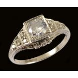 An Art Deco Diamond Ring millegrain-set old-cut stone with eight-cut stones to shoulders in