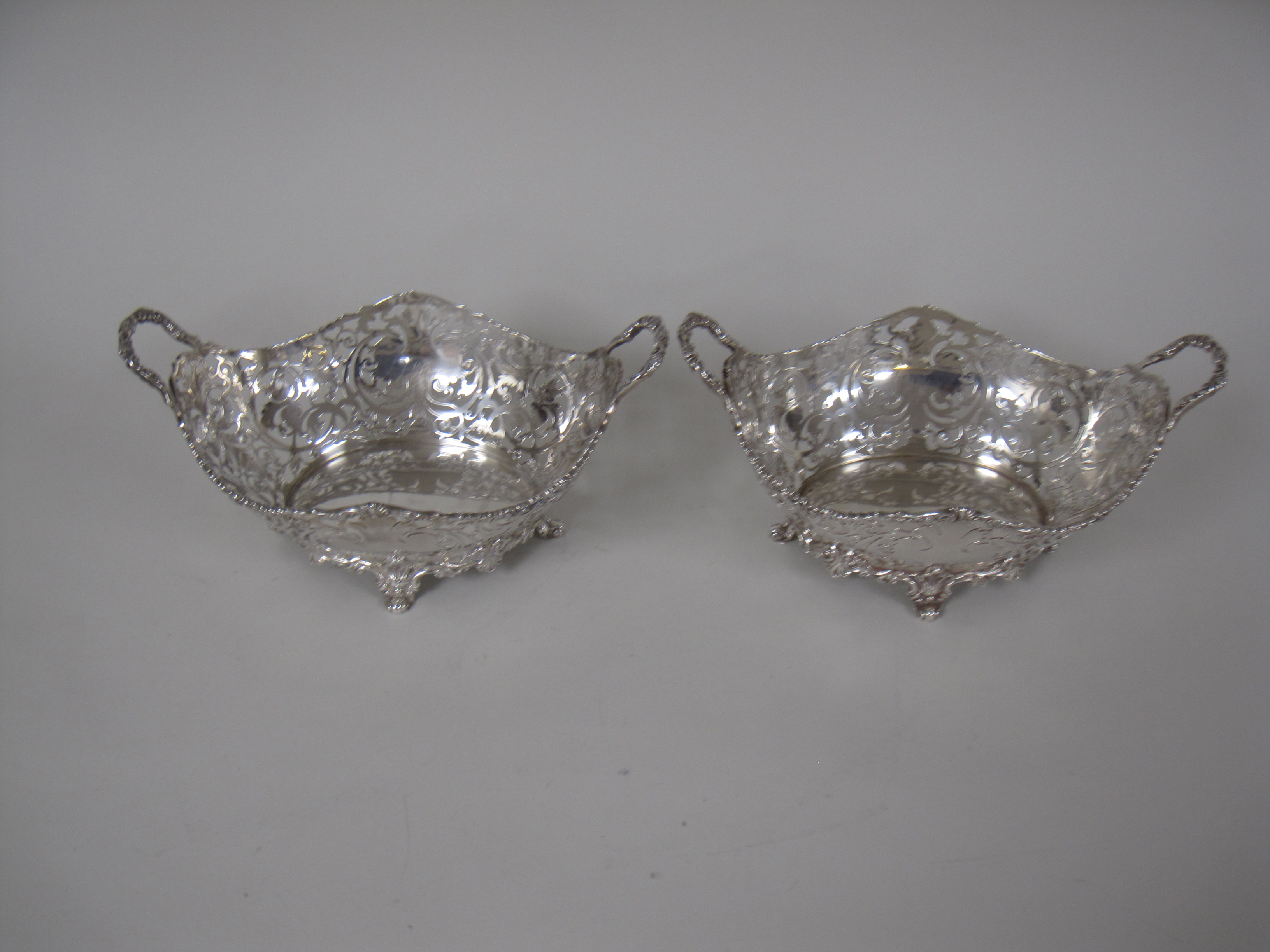 A pair of George V silver pierced oval two handled Baskets on scroll feet, London 1925, 10 x 6in, - Image 2 of 4
